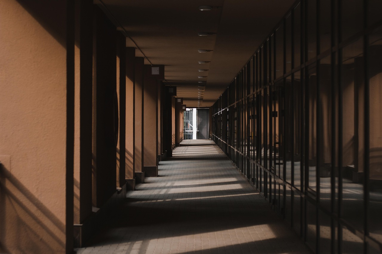 A corridor with raking architectural shadows