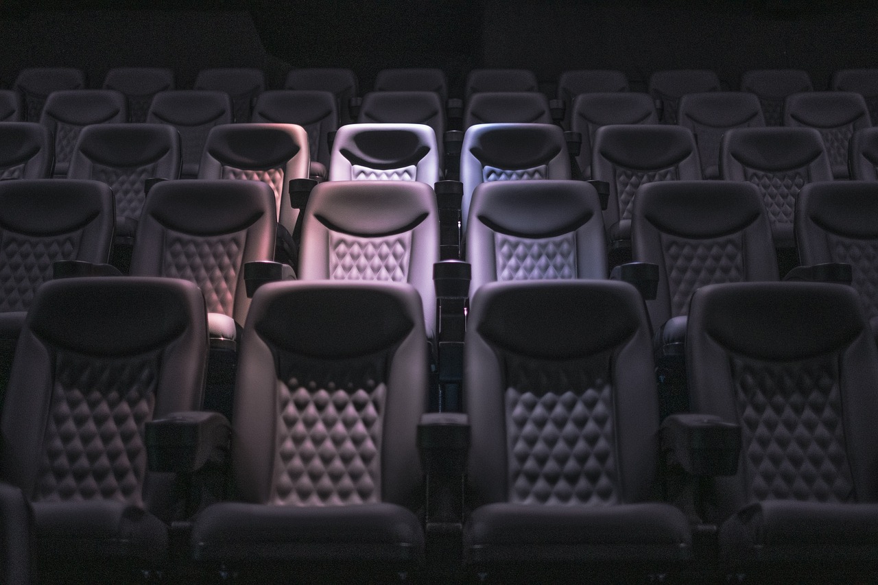 Rows of empty seats in a dark auditorium