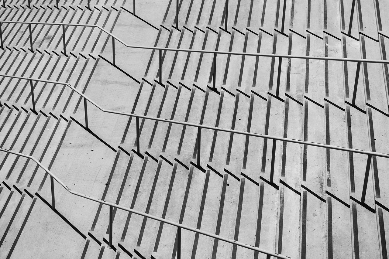 Geometric shadows across a concrete stairway