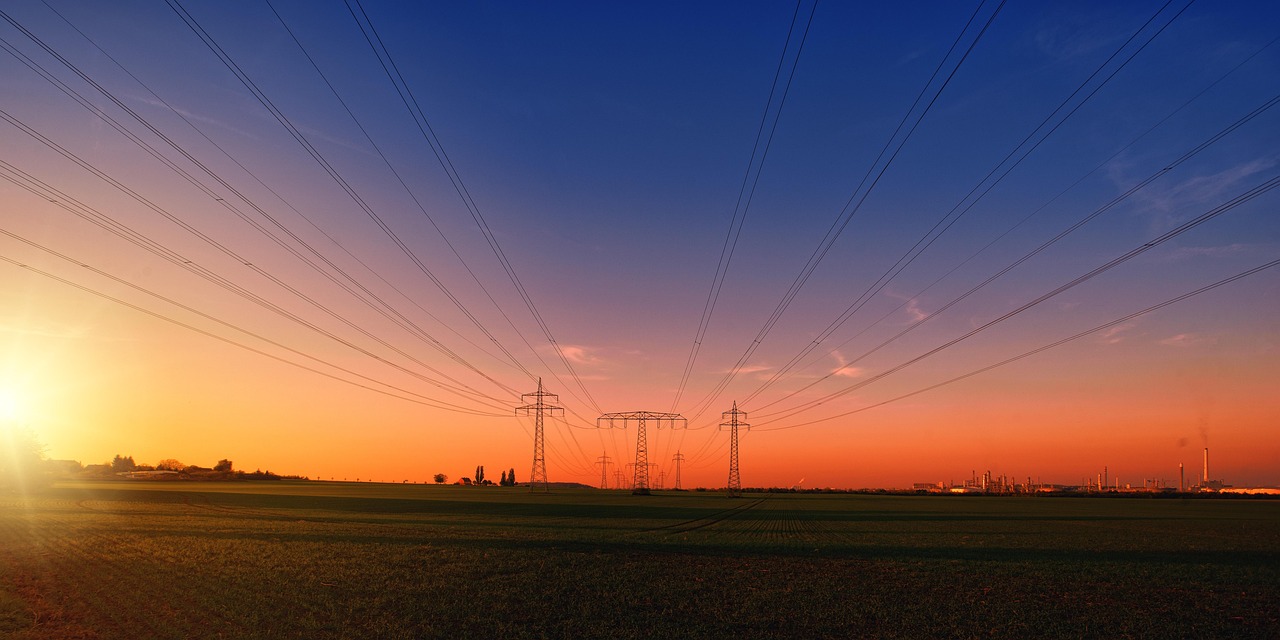 Electricity transmission lines against a sunset sky